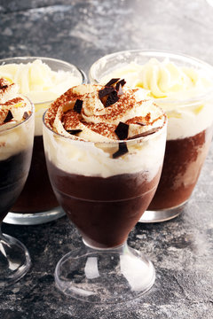 hot chocolate with cocoa and whipped cream on rustic background