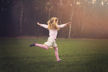 Fototapeta na wymiar young girl is running in the nature, spring concept
