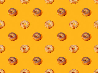 fresh buns on orange colorful background, seamless pattern