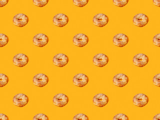 fresh buns on orange colorful background, seamless pattern