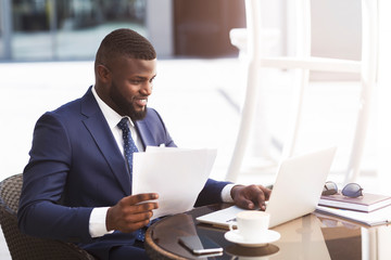 Fototapeta premium Business Guy Using Laptop Working Sitting In Cafe In City