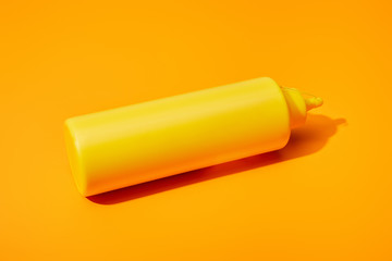 bottle of mustard on orange colorful background