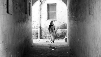 young girl with bag ober her head in Stonetown