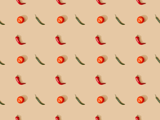 top view of red spicy chili peppers and jalapenos with tomatoes on beige background, seamless pattern