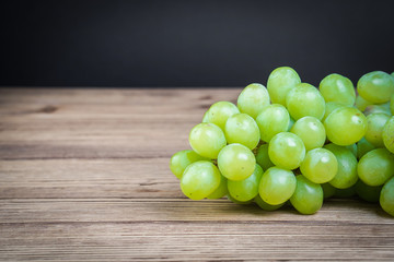 Vegetarian healthy food. Source of protein for vegetarians. Healthy eating: grapes on dark background.