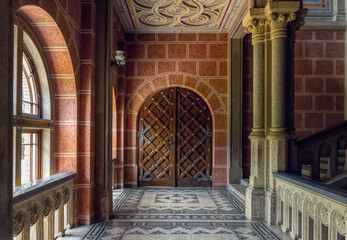 Chernivtsi city, Bukovina, Ukraine - June 12, 2018: ancient wrought-iron door and a marble staircase in the lobby of the old university building in the city of Chernivtsi. Medieval architecture © Maryna Konoplytska