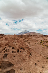 Rocky landscape mountain background. Dry, Barren desert, snowcapped mountains wilderness. Mountain range view. Salt Flats of Uyuni, Bolivia. Copy space, Rocks, blue sky, nature, hiking, sand dust