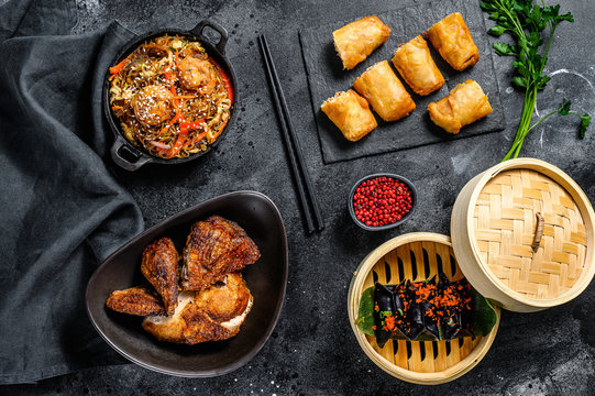 Chinese cuisine dishes set, food black background. Chinese noodles, dumplings, peking duck, dim sum, spring rolls. Famous. Top view