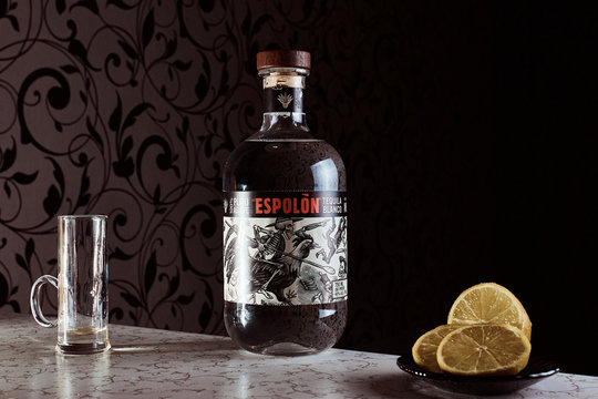 .Kiev, Ukraine - May 16, 2020: Closeup of Espolon Tequila made from 100% pure agave, blanco tequila bottle branding and lime.