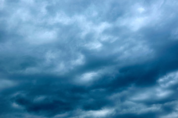Naklejka na ściany i meble Dark blue gloomy, formidable sky in the clouds.