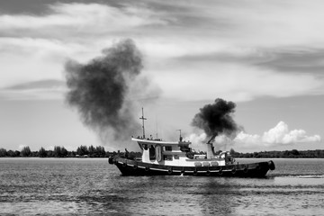 polluting boat on the river in Cambodia