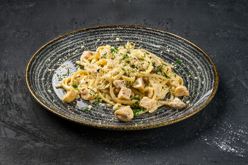 Pasta with mushrooms on black background