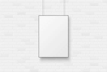 Blank poster on a white brick wal