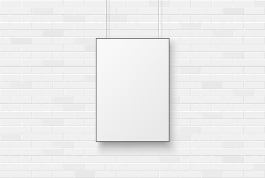 Blank poster on a white brick wal