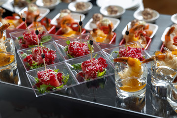 Slices of tuna sprinkled with grated boiled beets, decorated with lettuce. Beautiful skewers, serve on small transparent plates.