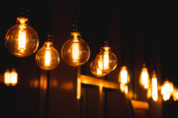 a lot of light bulbs on a black background in a dark room.
abstract background with lots of bulb...