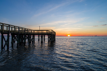 Fototapeta na wymiar A pier on Mobile Bay, Alabama at sunset 