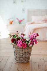Stylish room interior with big comfortable bed in pink color with lots of flowers.