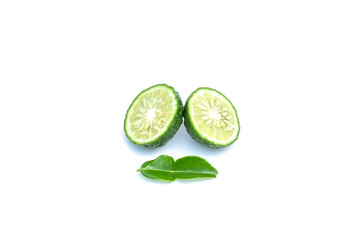 Sliced of citrus hystrix or Kaffir Lime are oranges native to tropical Asia, and green leaves isolated on white background