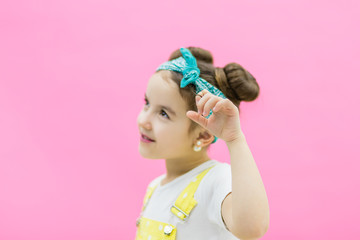 Cute girl keeping left hand up. Little girl looks suprised
