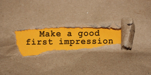 The text Make a good first impression appearing behind torn brown paper