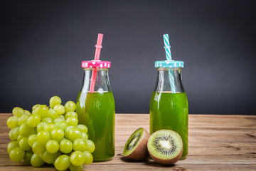 Vegetarian healthy food. Source of protein for vegetarians. Healthy eating: kiwi, grapes, juice on dark background.