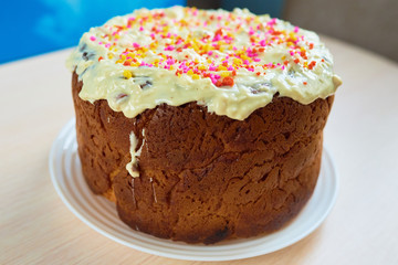 Easter cake with white chocolate icing and multi-colored sprinkles. Macro