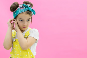 View of a girl wearing jumpsuit in polka-dot looking straight.