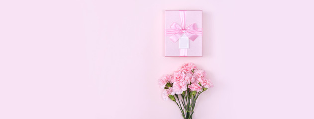 Obraz premium Mother's Day, Valentine's Day background design concept, beautiful pink carnation flower bouquet on pastel pink table, top view, flat lay, copy space.