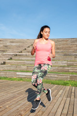 Fototapeta premium Woman doing exercise, skipping outdoors