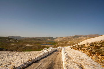 Lake Egrigol (eğrigöl), a hidden gem sitting at 2,350 meters in the foothills of Geyik Mountain in Antalya province, Surrounded by 3 or 4 meters of snow on one side and mountain wild flowers