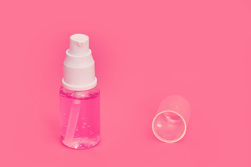 Medical hand hygiene product with pink liquid, spray sanitizer close-up. Hand washing in a coronavirus pandemic