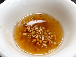 Garlic ginger chili fish sauce in white bowl for vietnamese pho soup