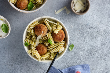 Pasta with pesto and meatballs. Copy space.