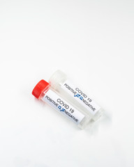 Testing for presence of coronavirus. Tube containing a swab sample that has tested positive for COVID-19.