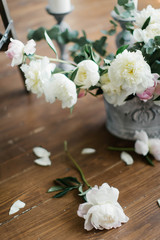 Fototapeta na wymiar Composition of white and pink peonies. White peony petals on the floor. Interior decoration with flowers. flower composition