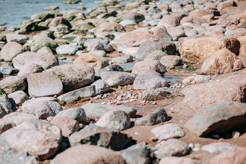 Ocean shore, sand and rocks on the sea coast.