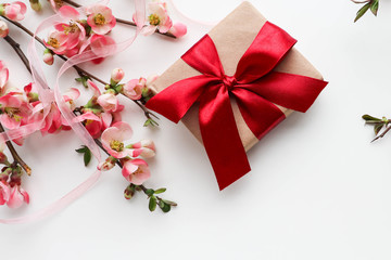 postcard mockup. flowering branch with pink flowers, gift box and space for text. congratulation. invitation