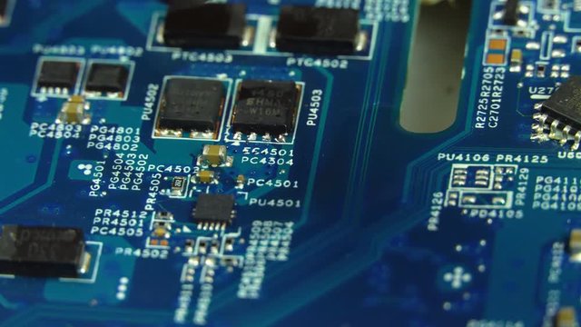 Hot air soldering. A master solders a mv workshop of a radio component using a soldering hair dryer.