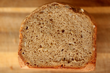 beautiful slice of a freshly baked loaf of homemade bread with a brown crust close-up, the concept of home-made cuisine, organic food, healthy eating