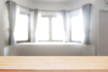 Empty wooden desk space over curtain and window background for product presentation.