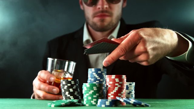 Super slow motion of poker player throwing cards towards camera. Filmed on high speed cinema camera, 1000fps.