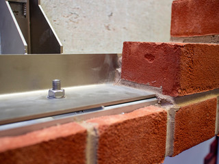 Steel reinforced brick wall construction