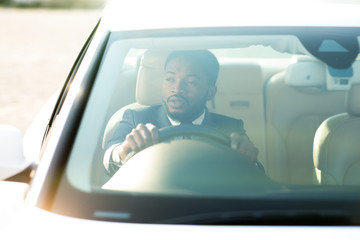 African Business Guy Holding Steering Wheel Sitting In New Auto