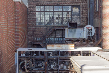Assorted industrial equipment on side of red brick factory
