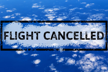Clouds and sky view from airplane window with text flight cancelled. Abstract blue texture. Flight cancellation due to impact of coronavirus COVID-19. Stay home. Travel, vacation ban concept.