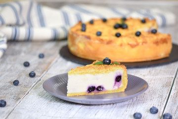 Piece of blueberry cheesecake on plate. Sweet cheesecake