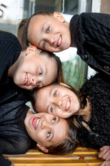 Portrait of group of female preteen faces. Girles dressed black clothes and smiling