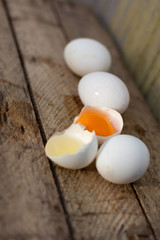 few white chicken eggs on   wooden crate