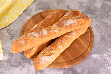 French baguettes on wooden board. Delicious french bread. Close-up.